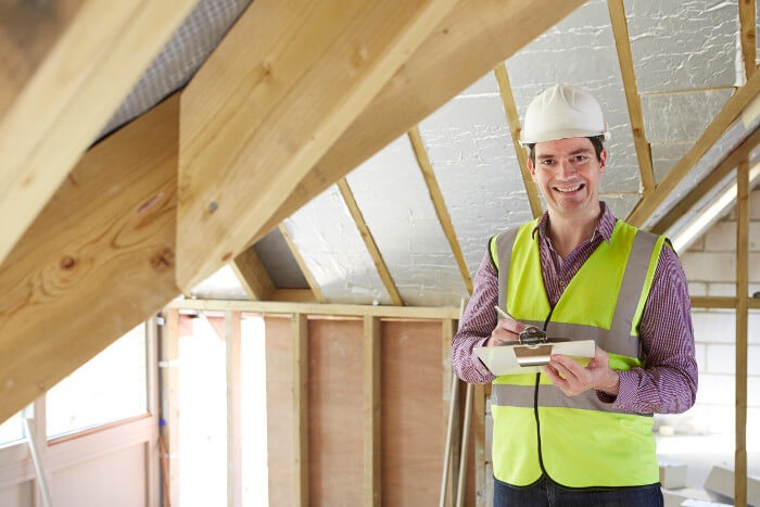 Building inspector looking at roof of new property