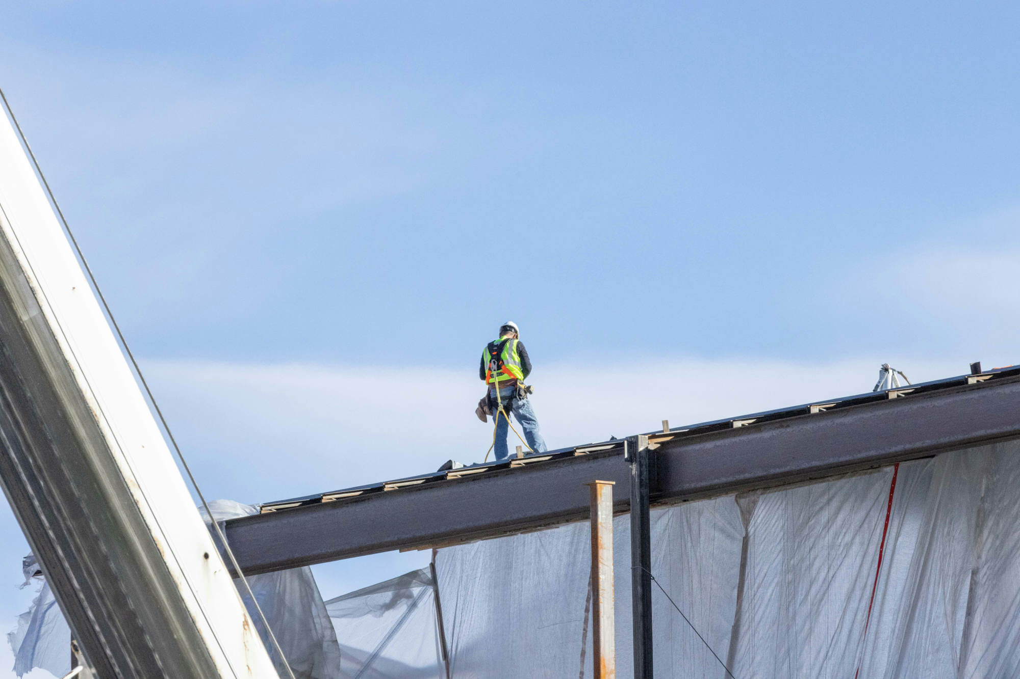 Man standing on top of a metal structure